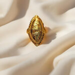“DivyGold 1 gram gold-plated marquise shaped traditional ring on silk fabric background”