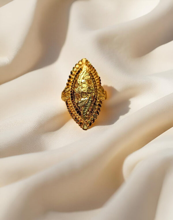 “DivyGold 1 gram gold-plated marquise shaped traditional ring on silk fabric background”