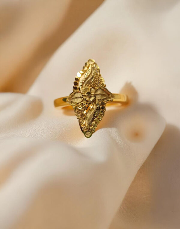 “DivyGold 1 gram gold-polished ethnic leaf motif ring displayed on soft beige fabric background”
