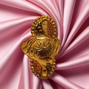 "DivyGold traditional ethnic ring with 1 gram gold polish and red enamel design placed on pink satin fabric"