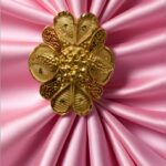 “DivyGold 1 gram gold-plated floral blossom statement ring on pink satin fabric”